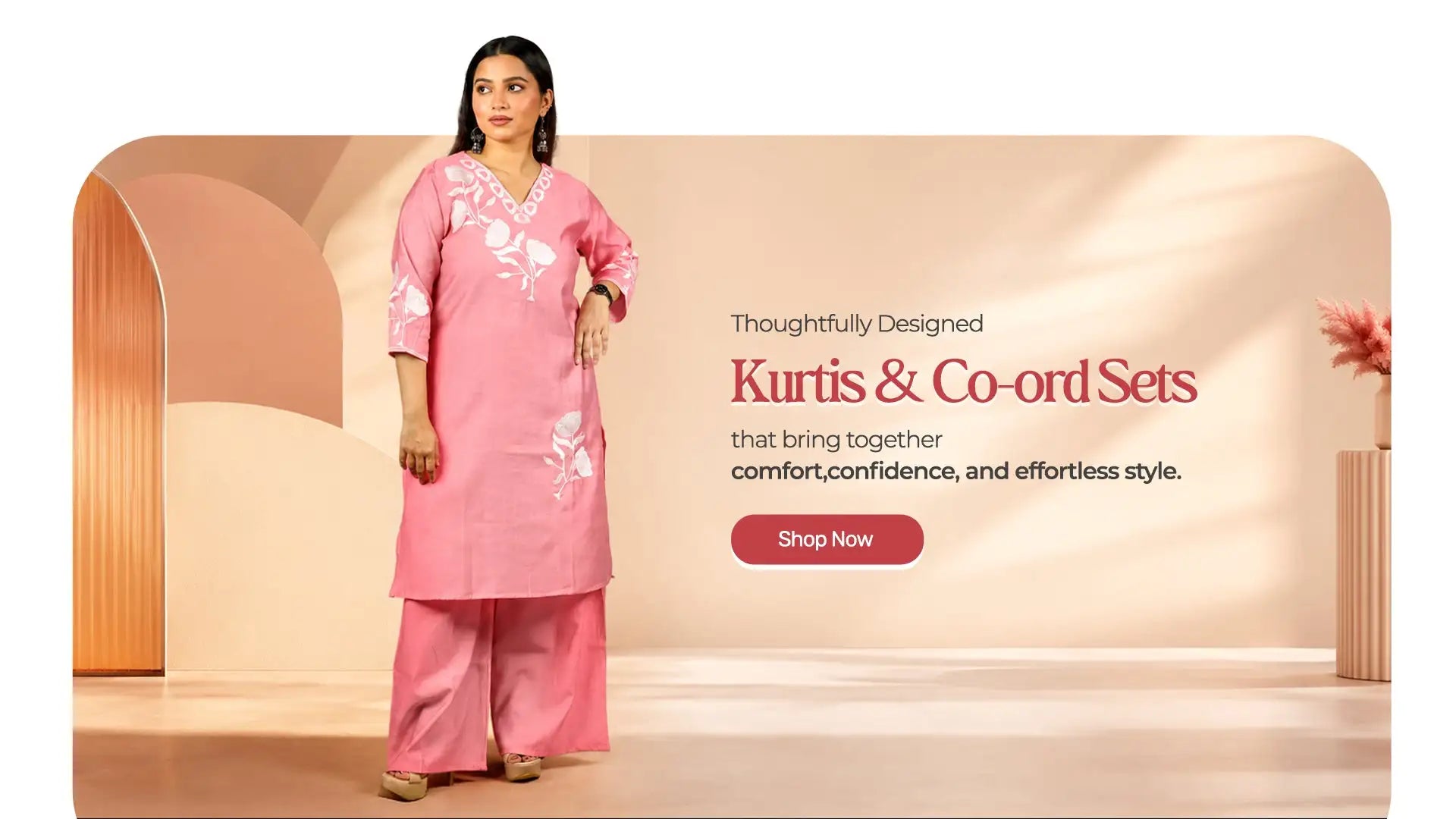 A soft pink kurti and co-ord set featuring delicate white floral embroidery along the neckline and sleeves.